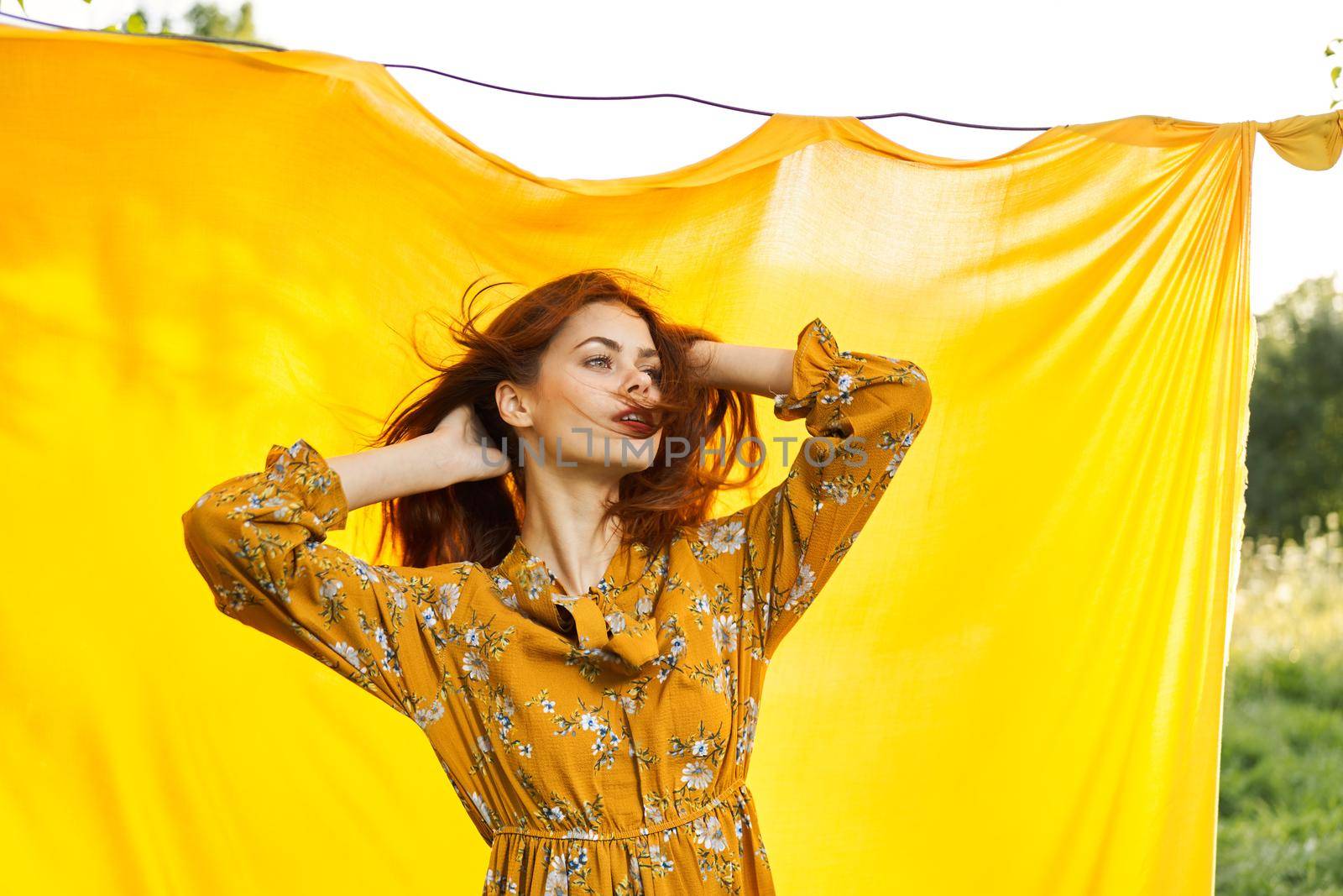 woman in dress posing nature yellow cloth fresh air. High quality photo