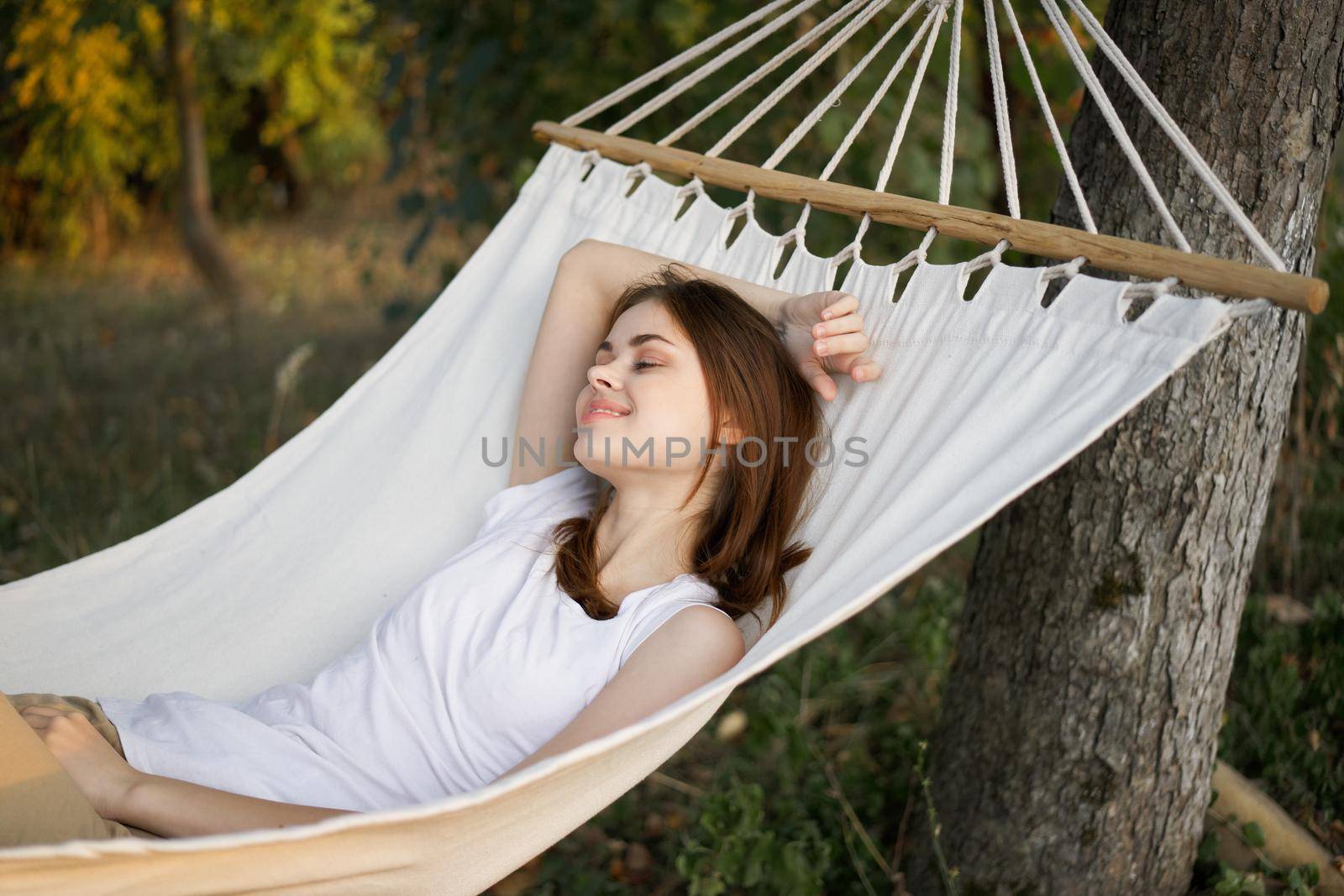 cheerful woman lies in a hammock rest nature fresh air. High quality photo