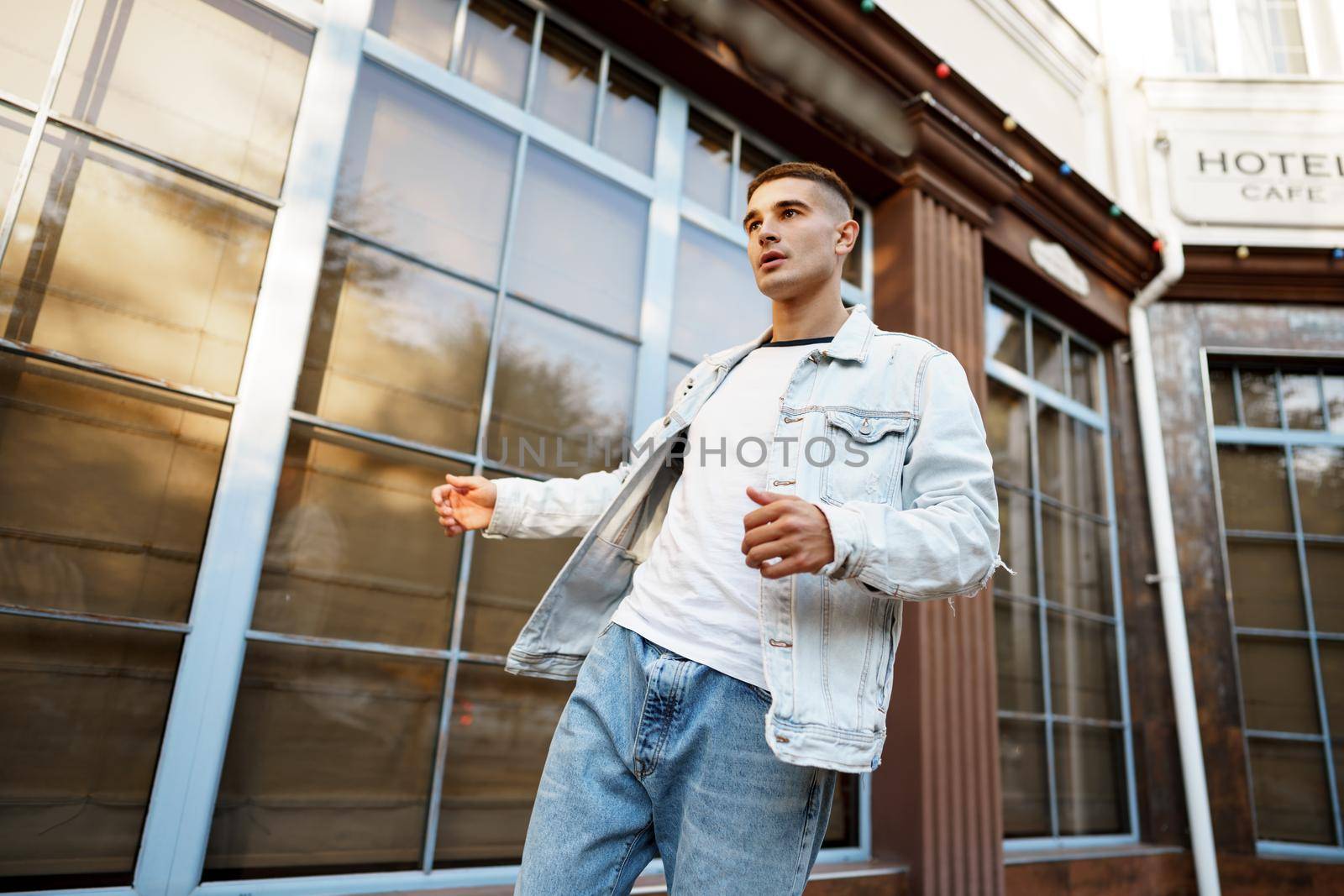 Portrait of handsome young casual man walking on the city street