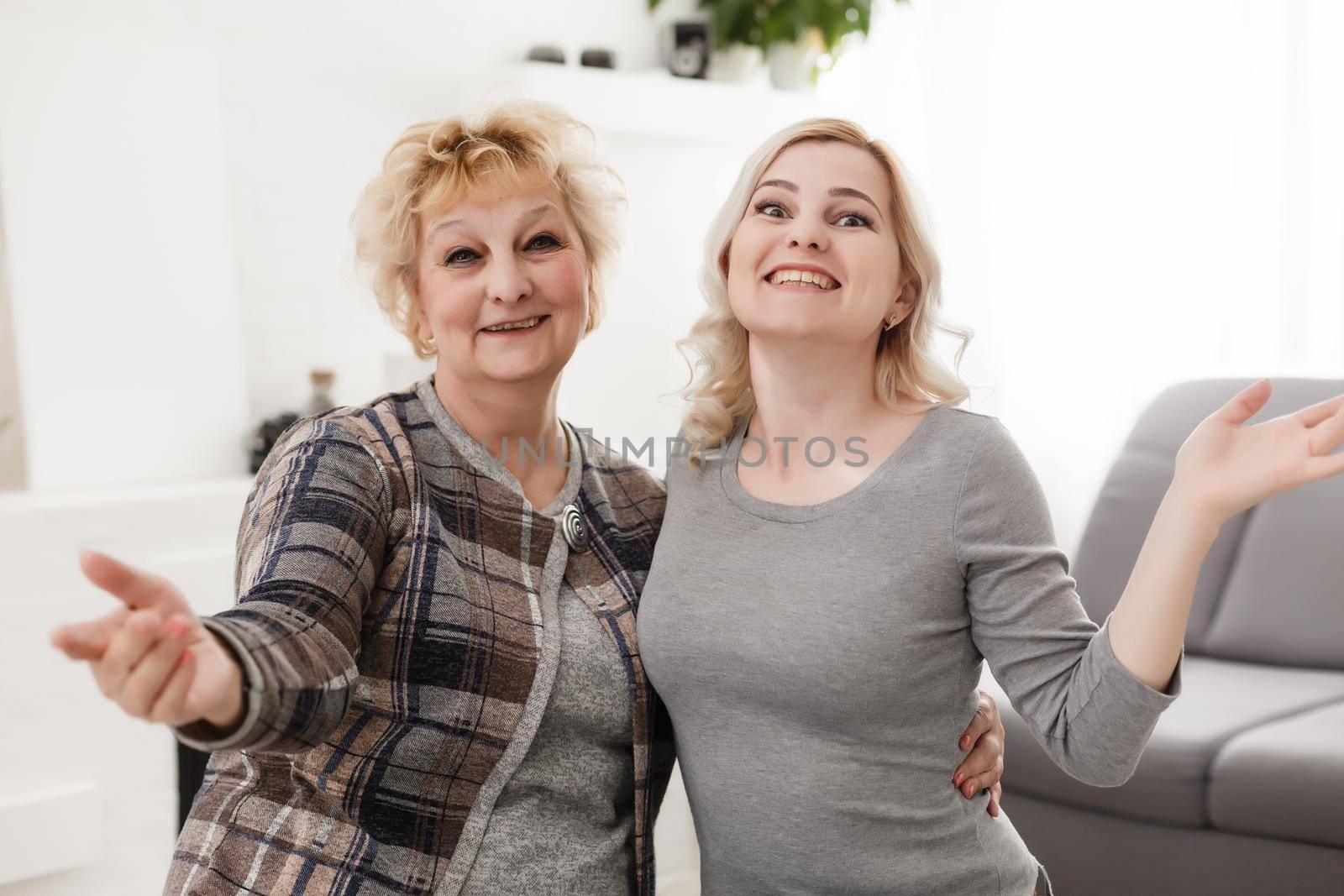 Self portrait of charming pretty stylish positive cheerful mom and adult child shooting selfie on front camera gesturing v-sign with two fingers isolated on grey background rest relax leisure concept