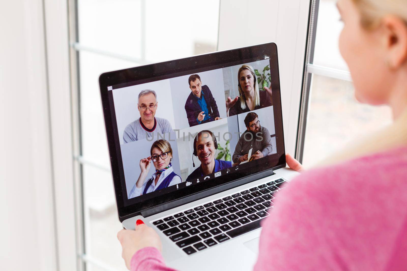 Woman Working From Home Having Group Videoconference On Laptop by Andelov13