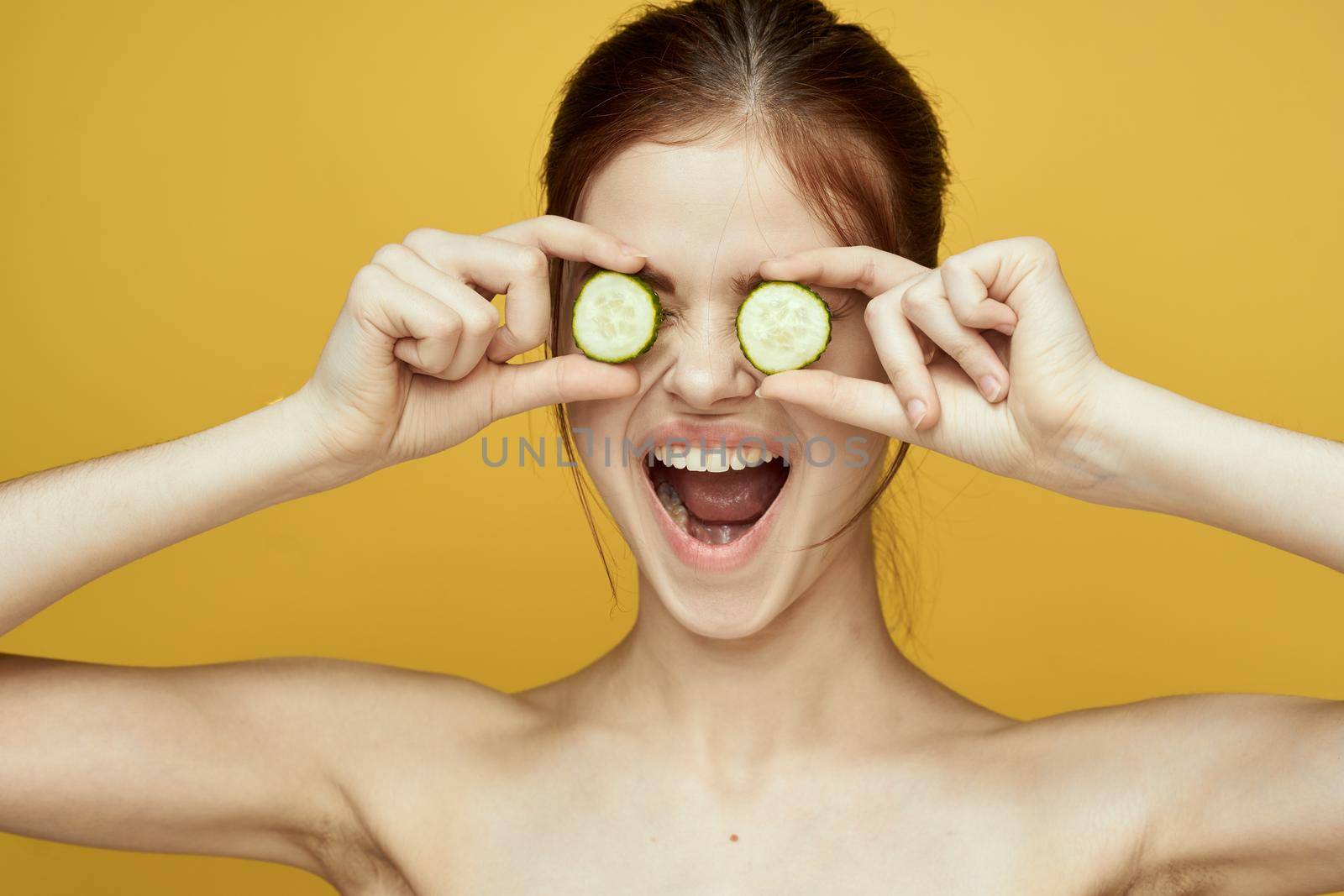 cheerful woman with cucumber vitamin skin care natural product. High quality photo