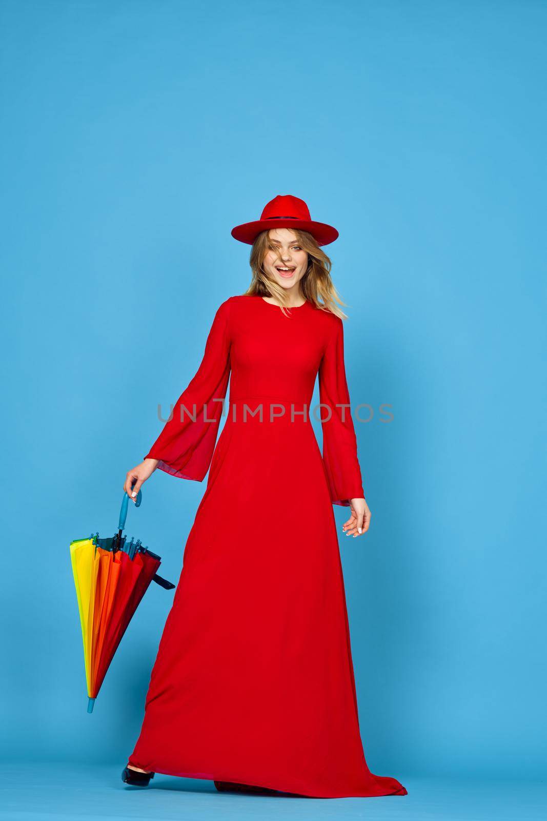 woman in red dress multicolored umbrella blue background by Vichizh