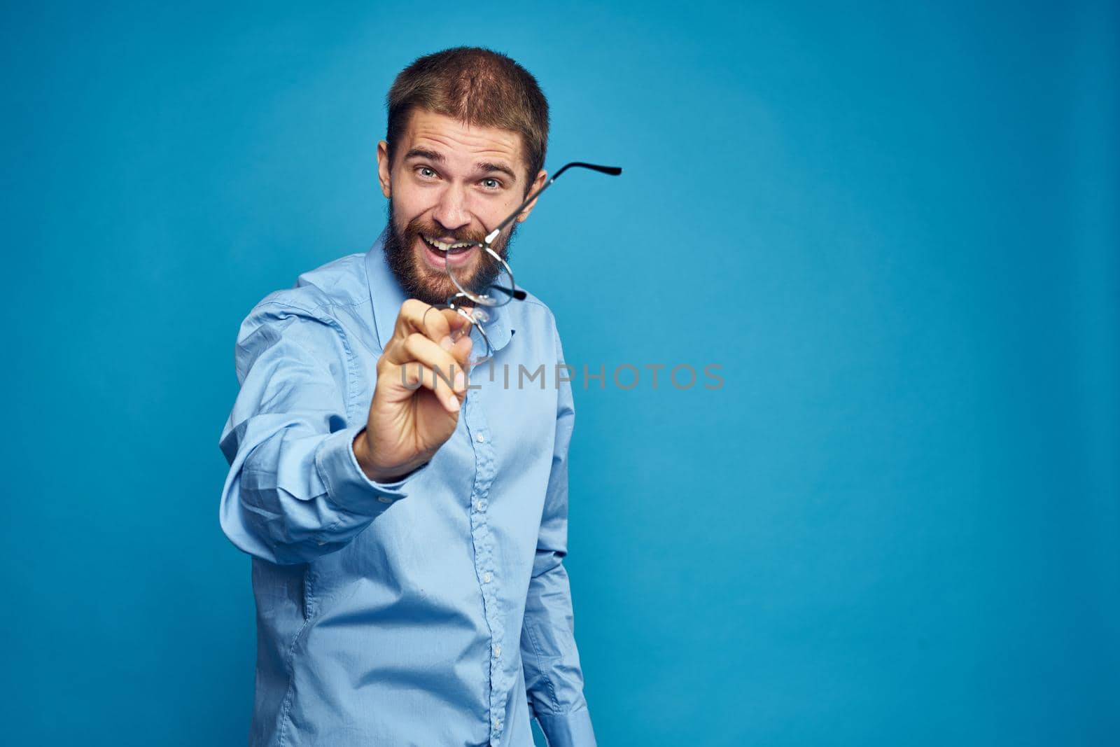 business man with glasses emotions blue background. High quality photo