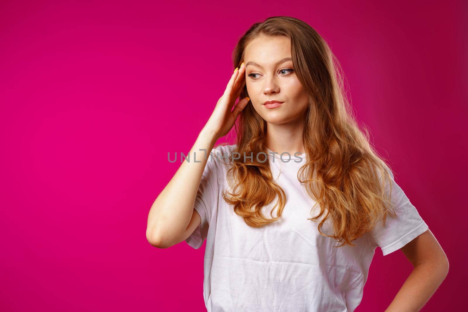 Young beautiful woman suffering from headache with hands on head close up
