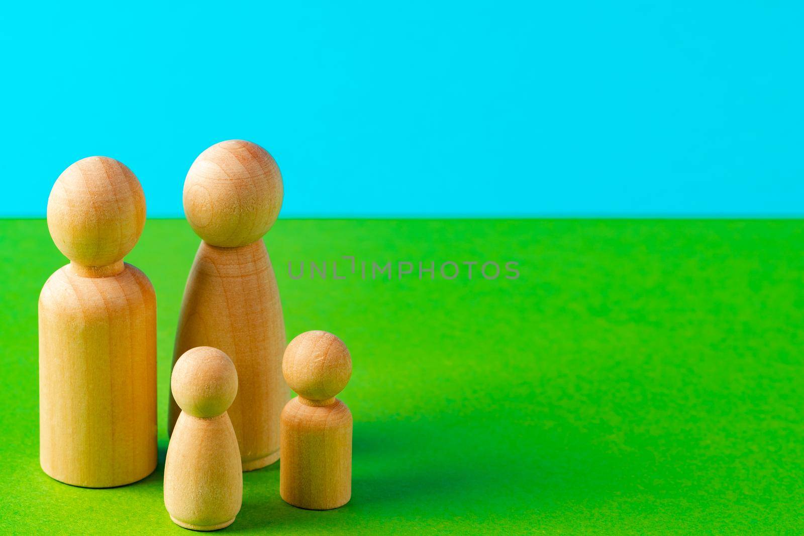 Small wooden figures of family members close up. Family relationship symbol