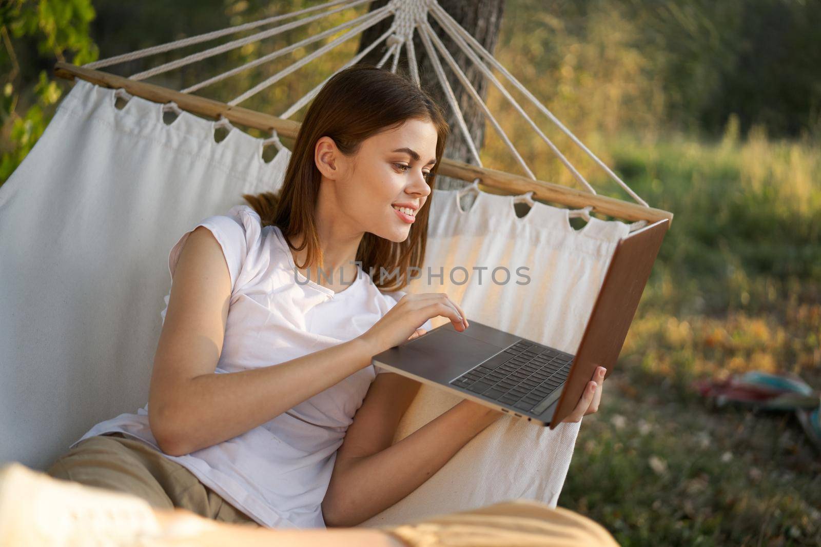 woman with laptop and lies in a hammock vacation nature freelance by Vichizh