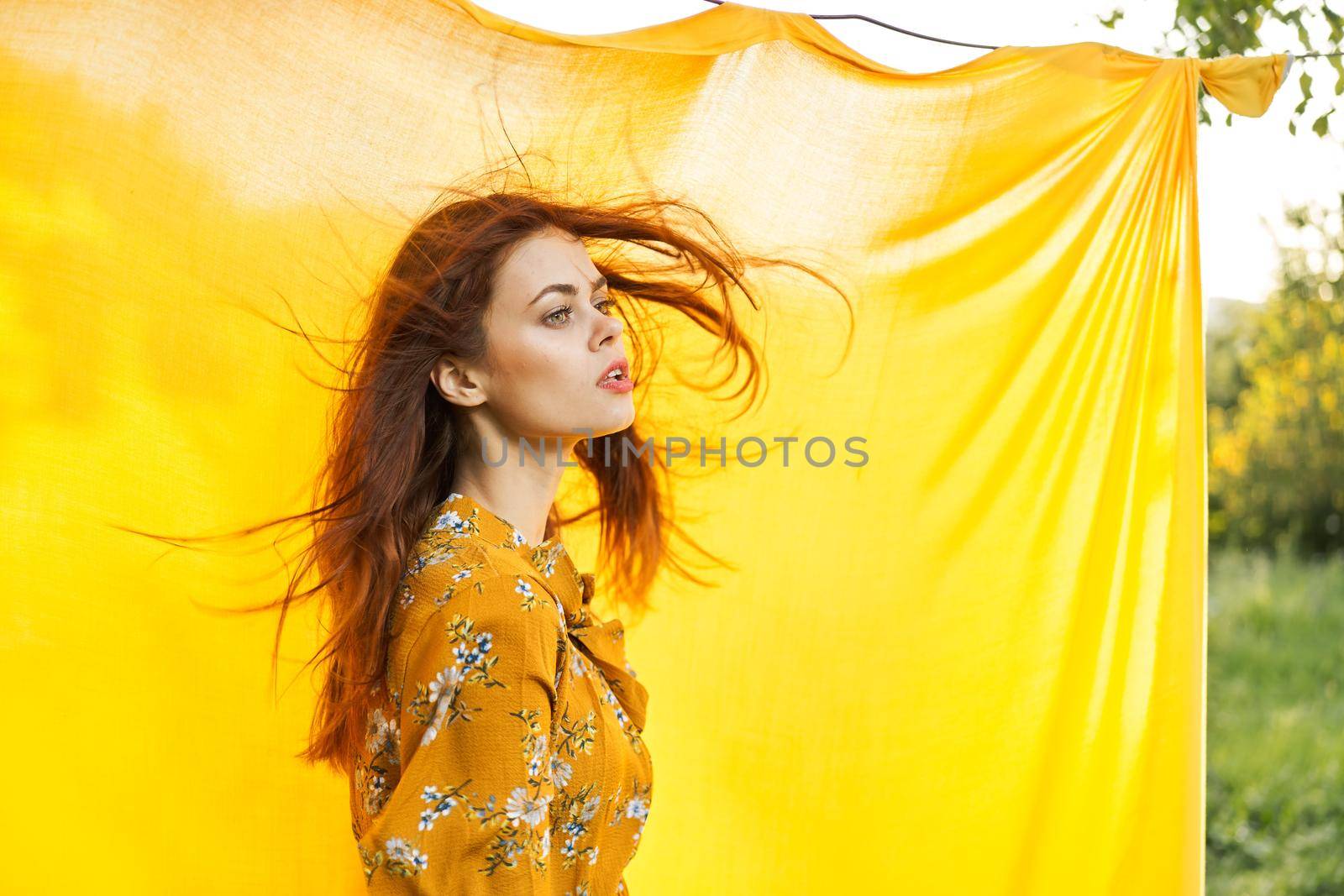 woman in dress posing nature yellow cloth fresh air. High quality photo