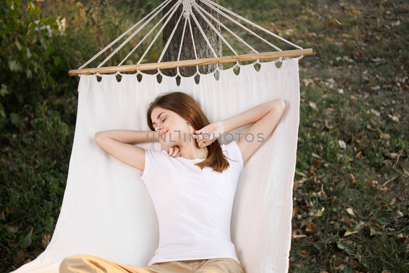 woman relaxing in nature in a hammock garden fresh air. High quality photo
