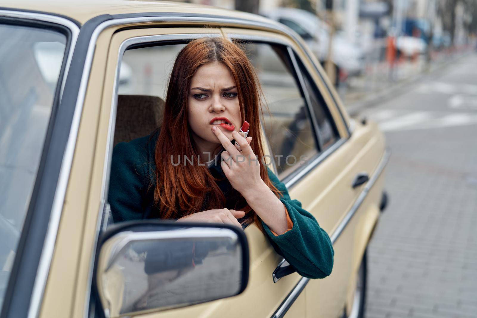 woman peeking out of car trip lifestyle fashion. High quality photo