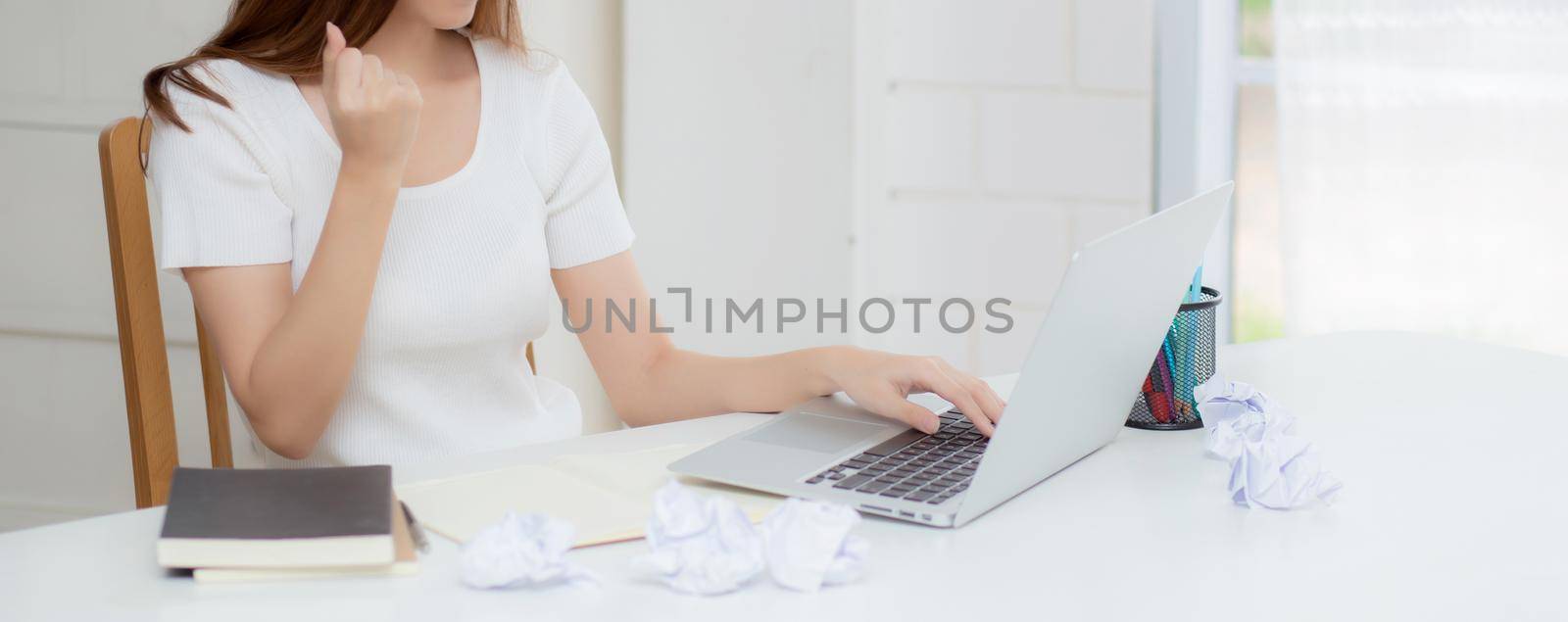 Young asian woman confident working at home with laptop computer and thinking idea for planning, freelance happy girl expression with excited and success using notebook thought, business concept. by nnudoo