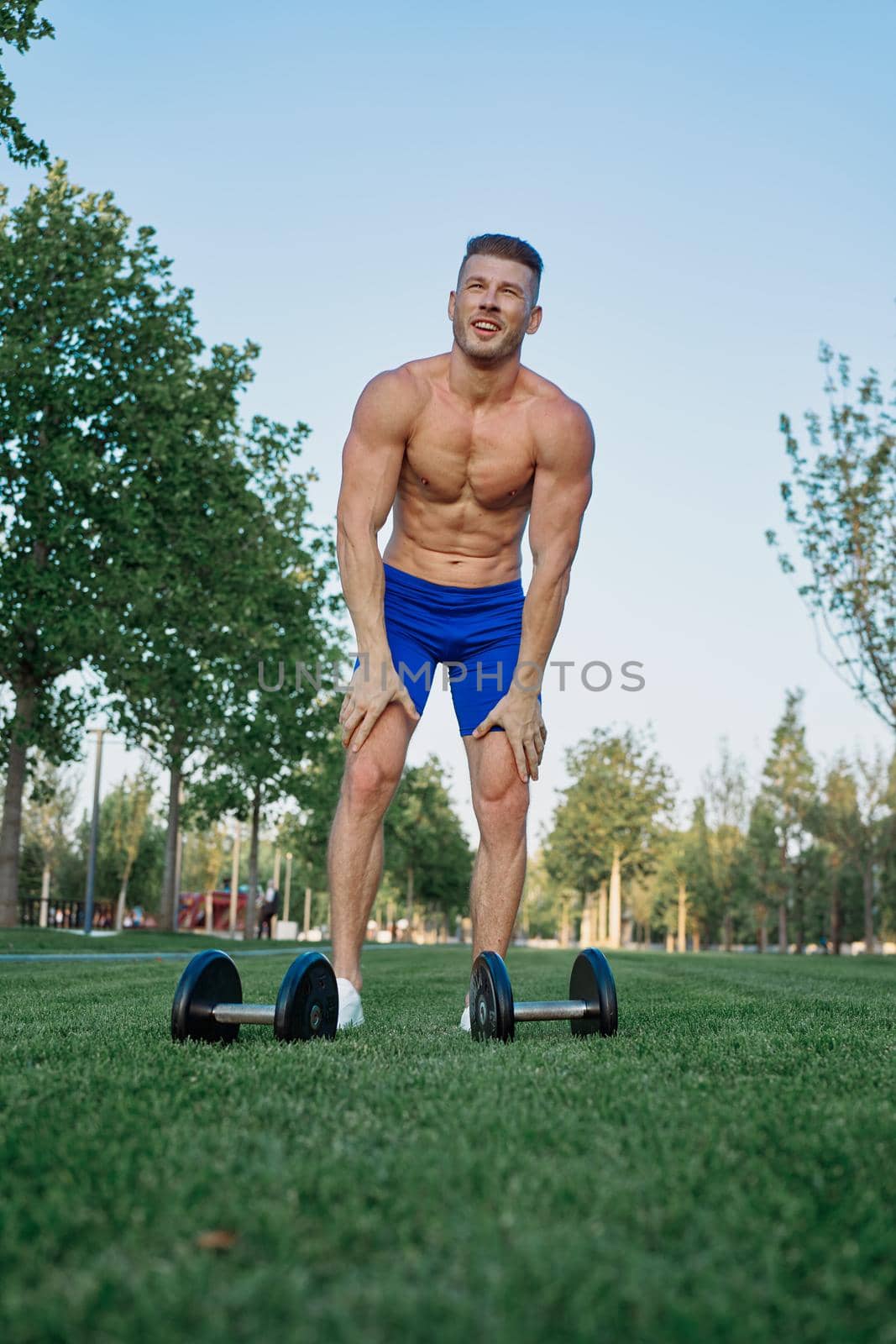 sporty man in park exercise crossfit workout. High quality photo