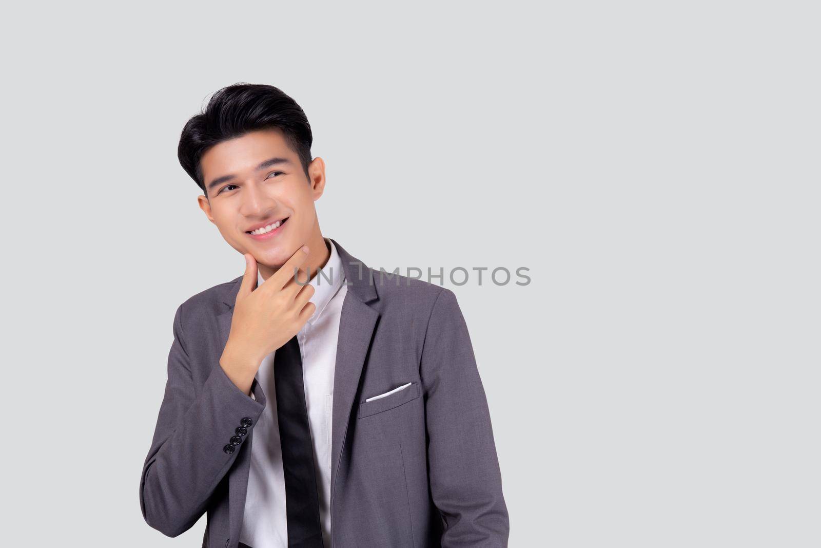 Portrait young asian business man in suit with smart thinking idea isolated on white background, businessman standing and planning for success, handsome manager or executive, emotion and expression. by nnudoo