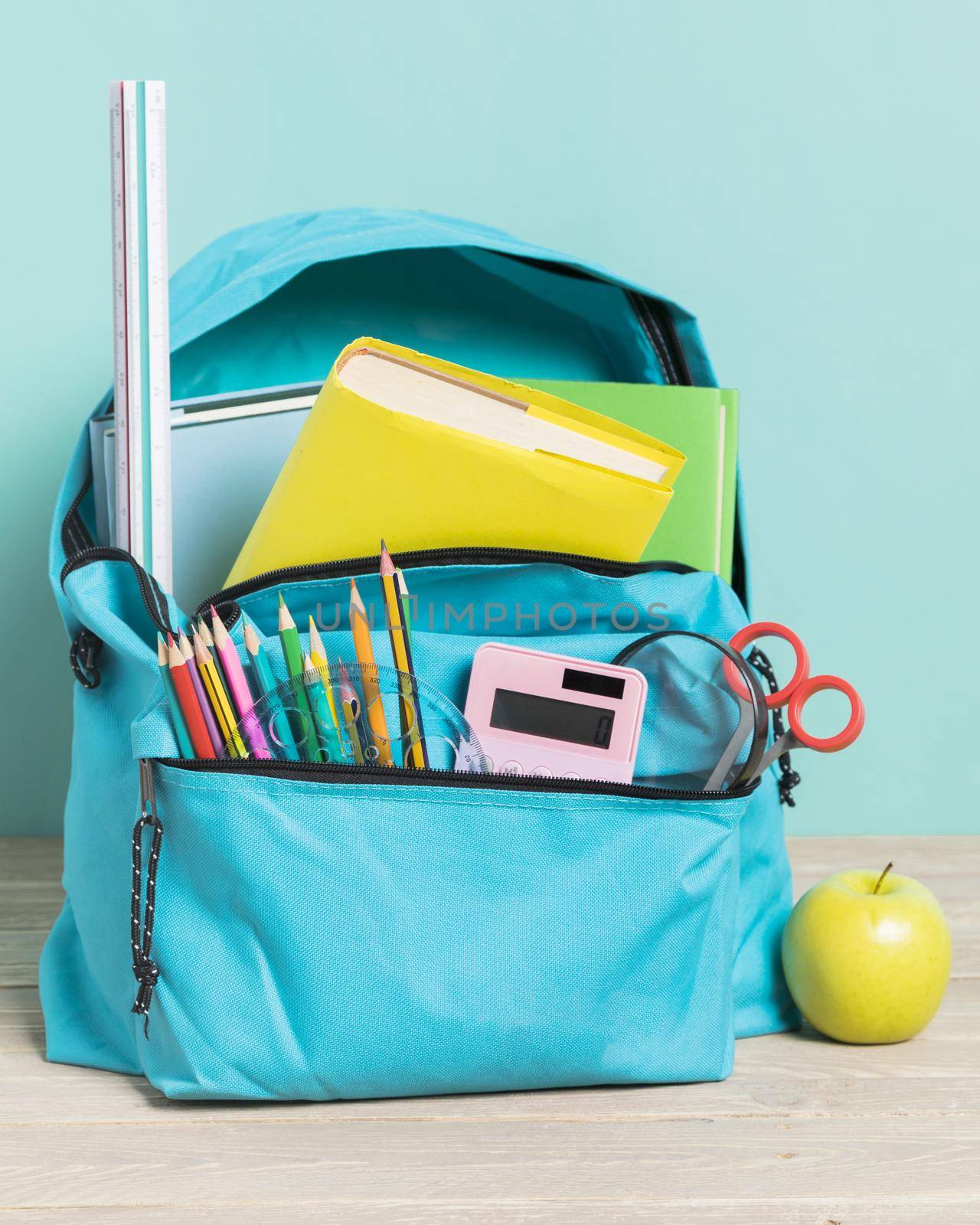 blue school bag with essential supplies by Zahard