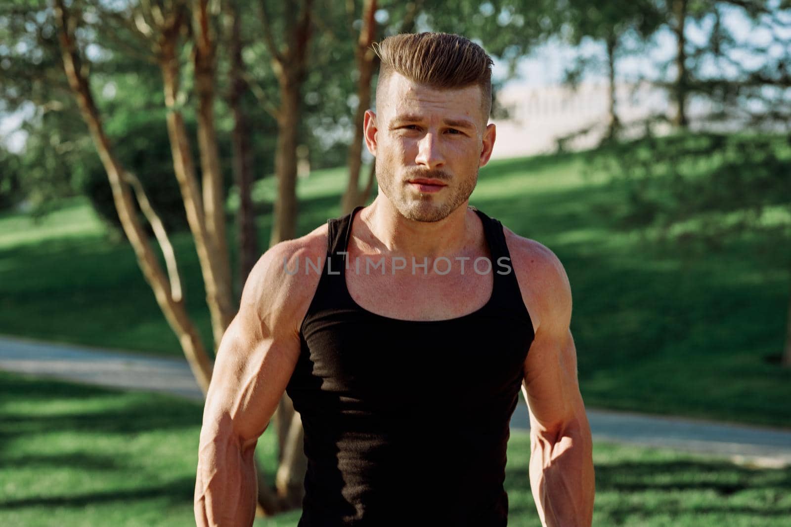 pumped up sports Vykhino in the park with dumbbell workout. High quality photo