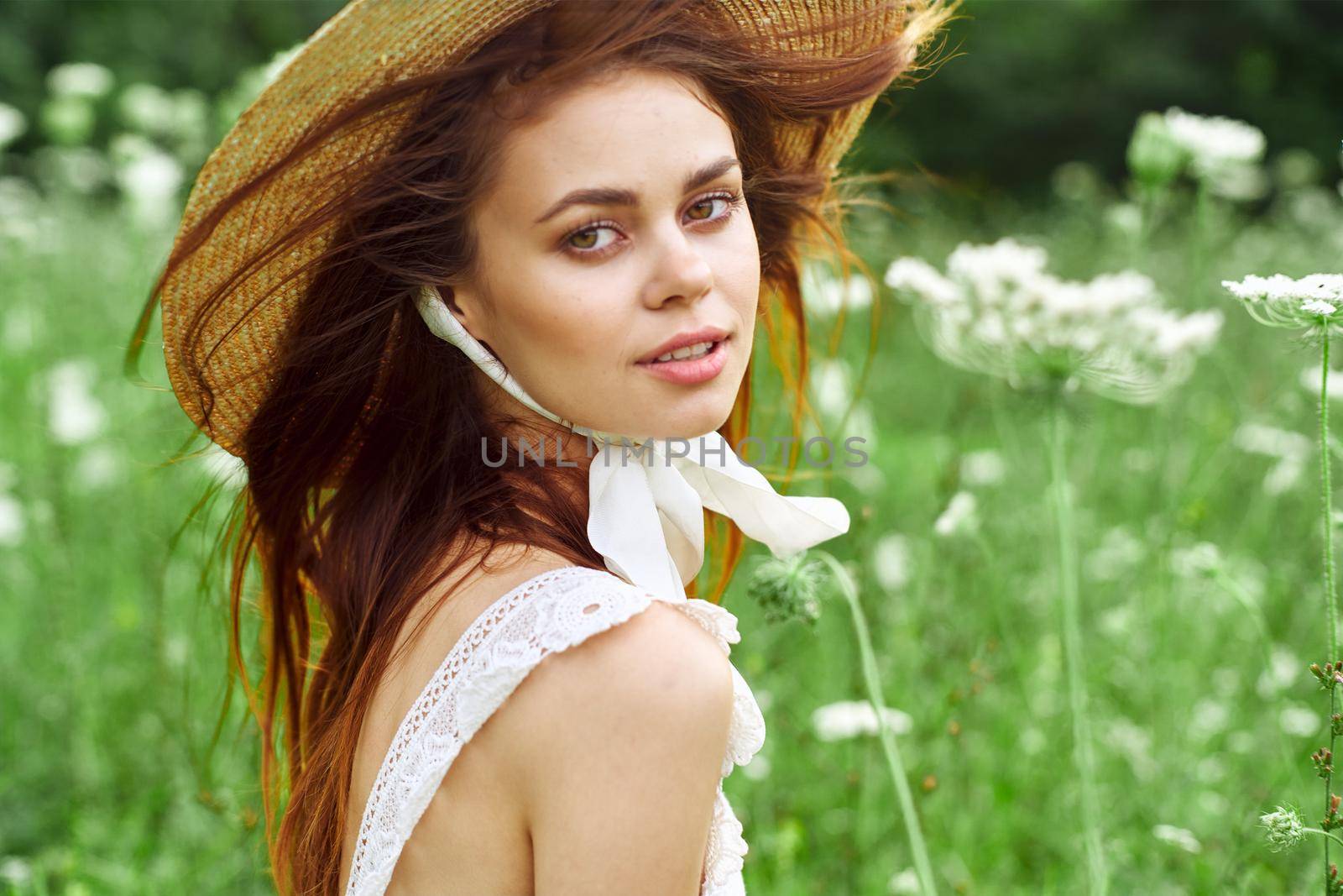 pretty woman with hat nature field flowers fresh air. High quality photo