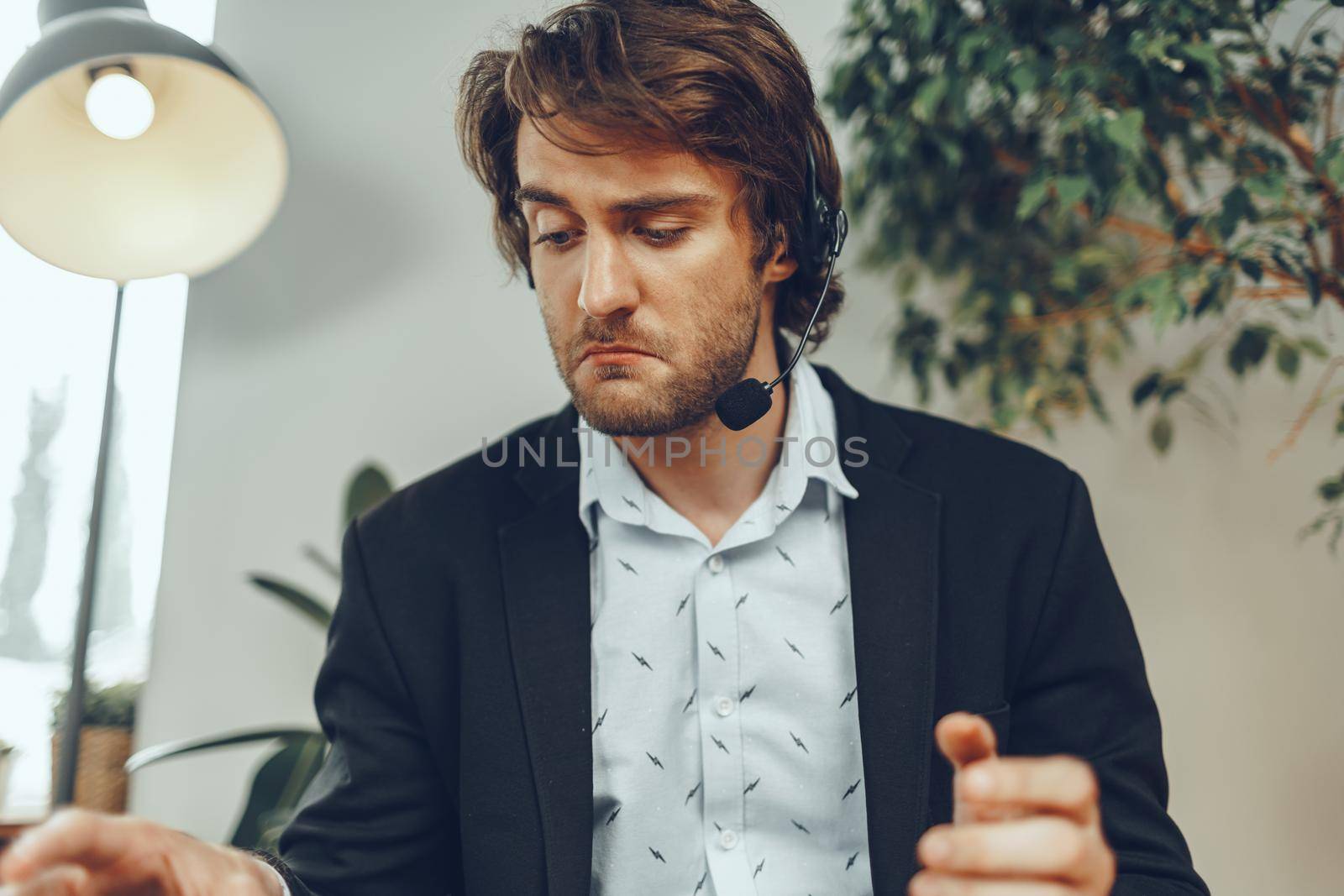 Bearded man businessman with headset having online business conversation close up