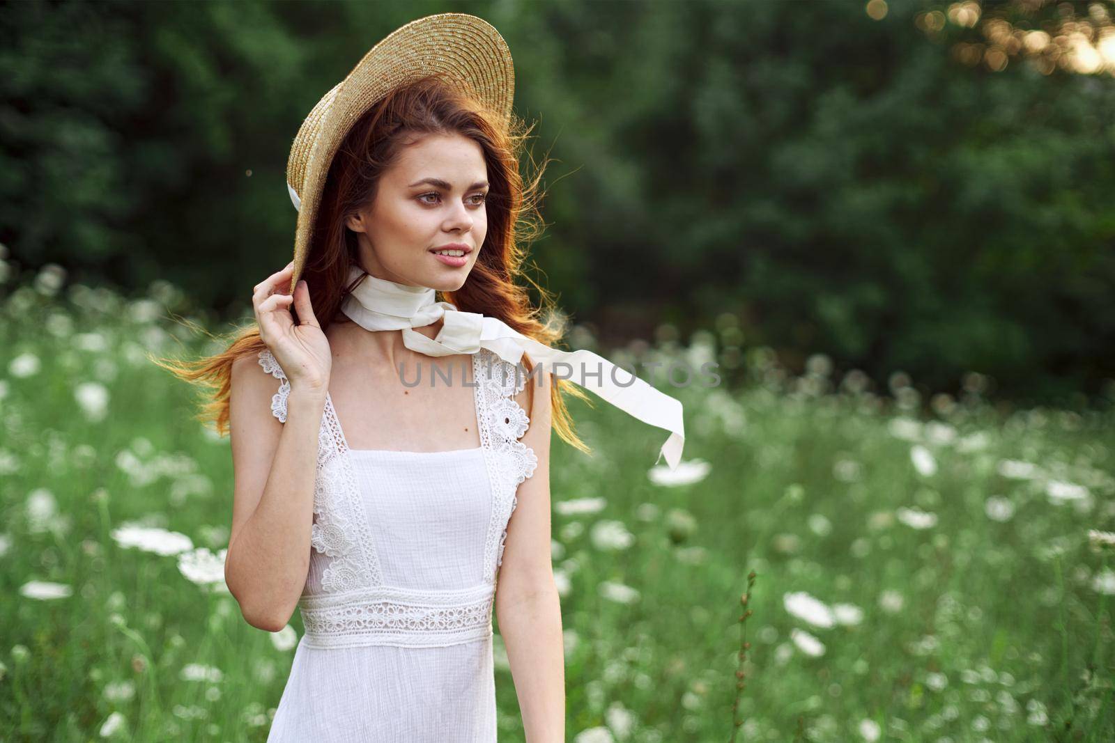 Woman in white dress on nature flowers rest charm. High quality photo