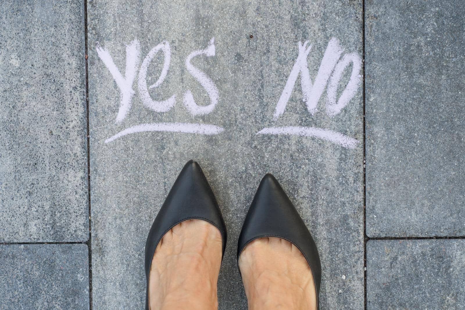 Businesswoman in black shoes, deciding where to go, yes or no