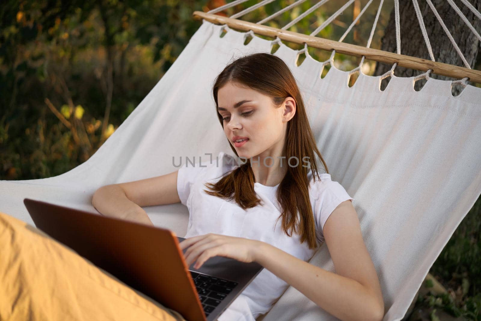 woman lies in the corner with laptop vacation nature technology. High quality photo