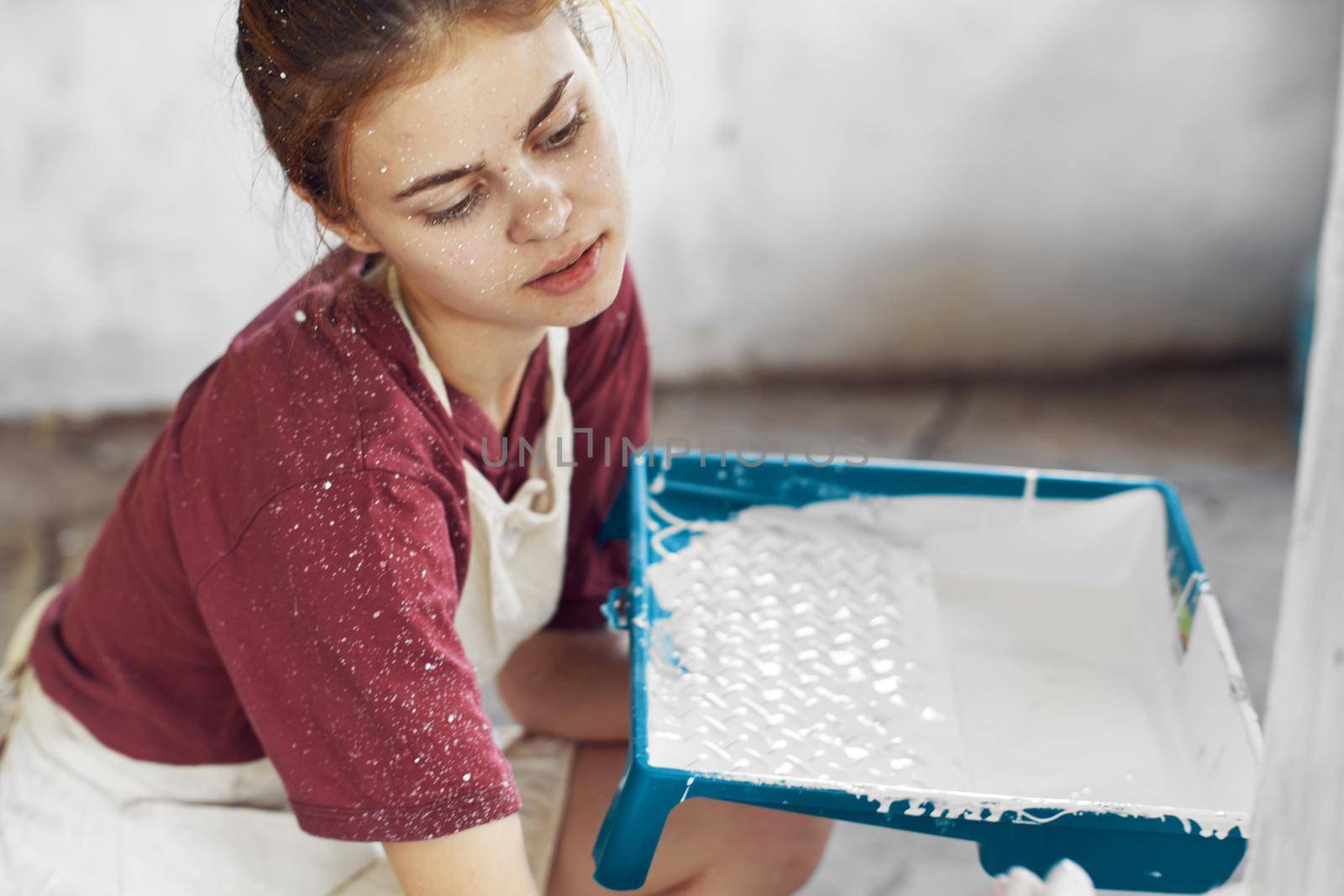 cheerful woman paints a room in a house renovation interior. High quality photo