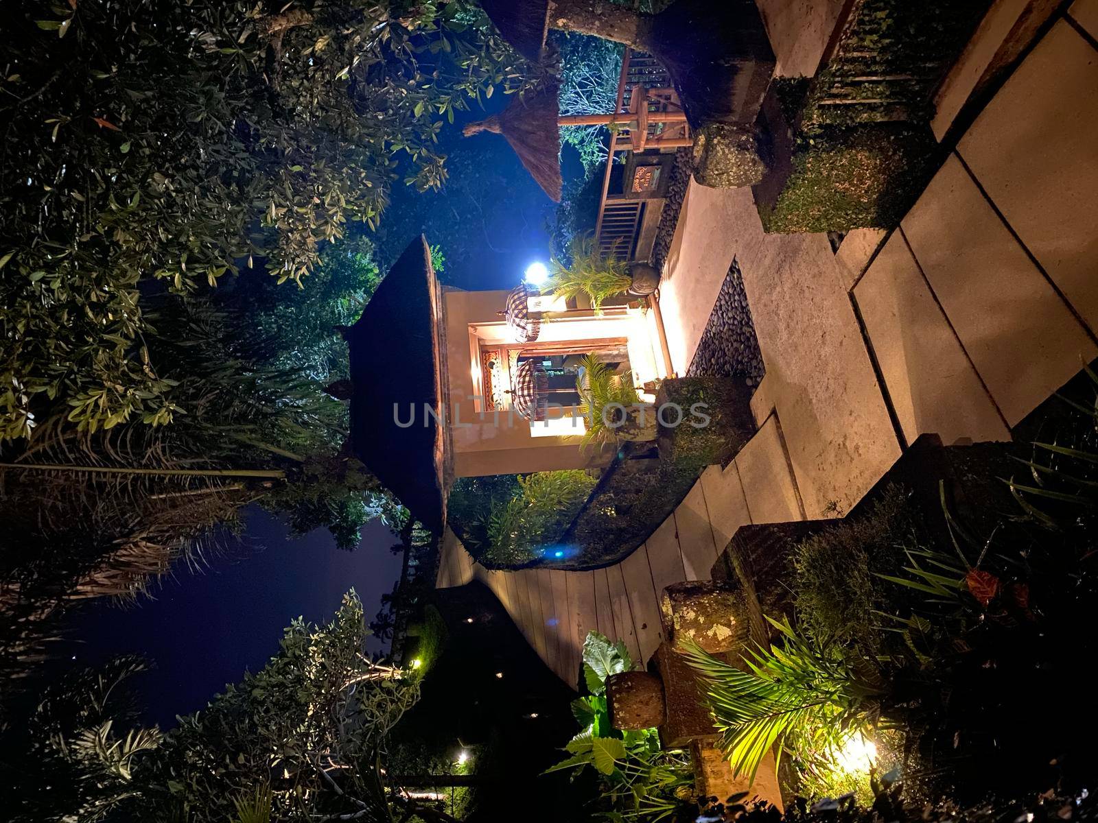 Luxury Villa at night time Ubud Bali Indonesia- stock photo by kaliaevaen