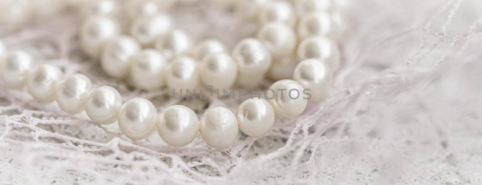 Nature white string of pearls in soft focus, with highlights by Olayola