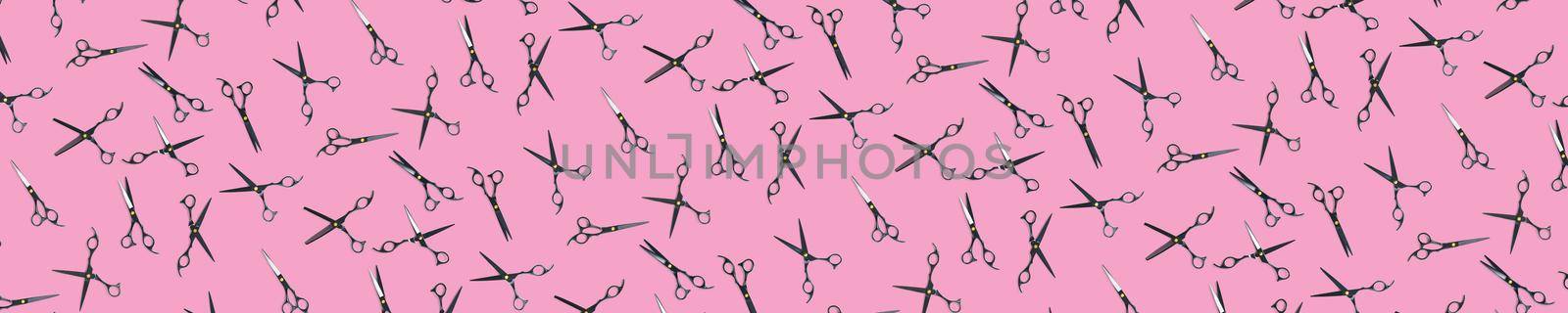 Background of black scissors. professional hairdresser black scissors isolated on pink. Black barber scissors, close up. pop art background, for prints or posters. not seamless pattern