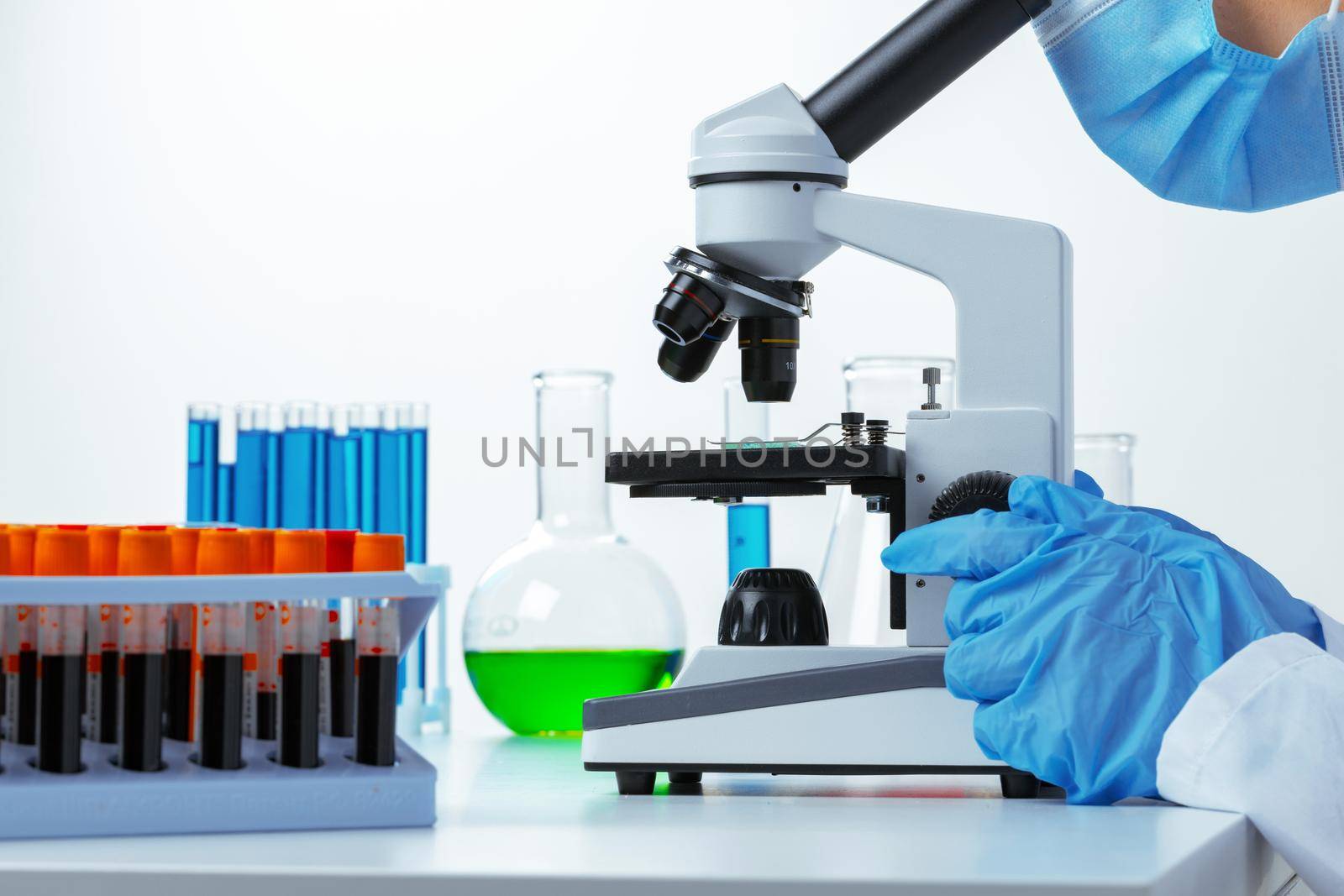 Close up photo of woman scientist working with microscope in laboratory