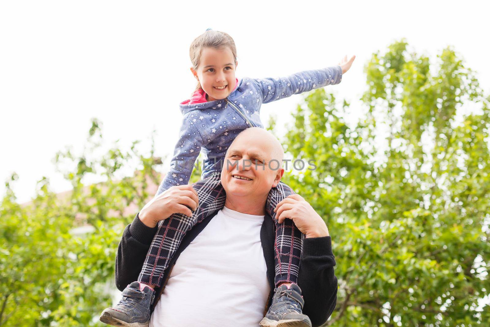 Beautiful granddaughter visiting her elderly kind grandfather. by Andelov13