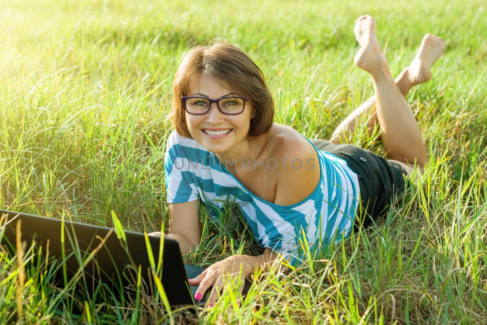 Adult beautiful woman using laptop in nature, outdoor portrait business woman.