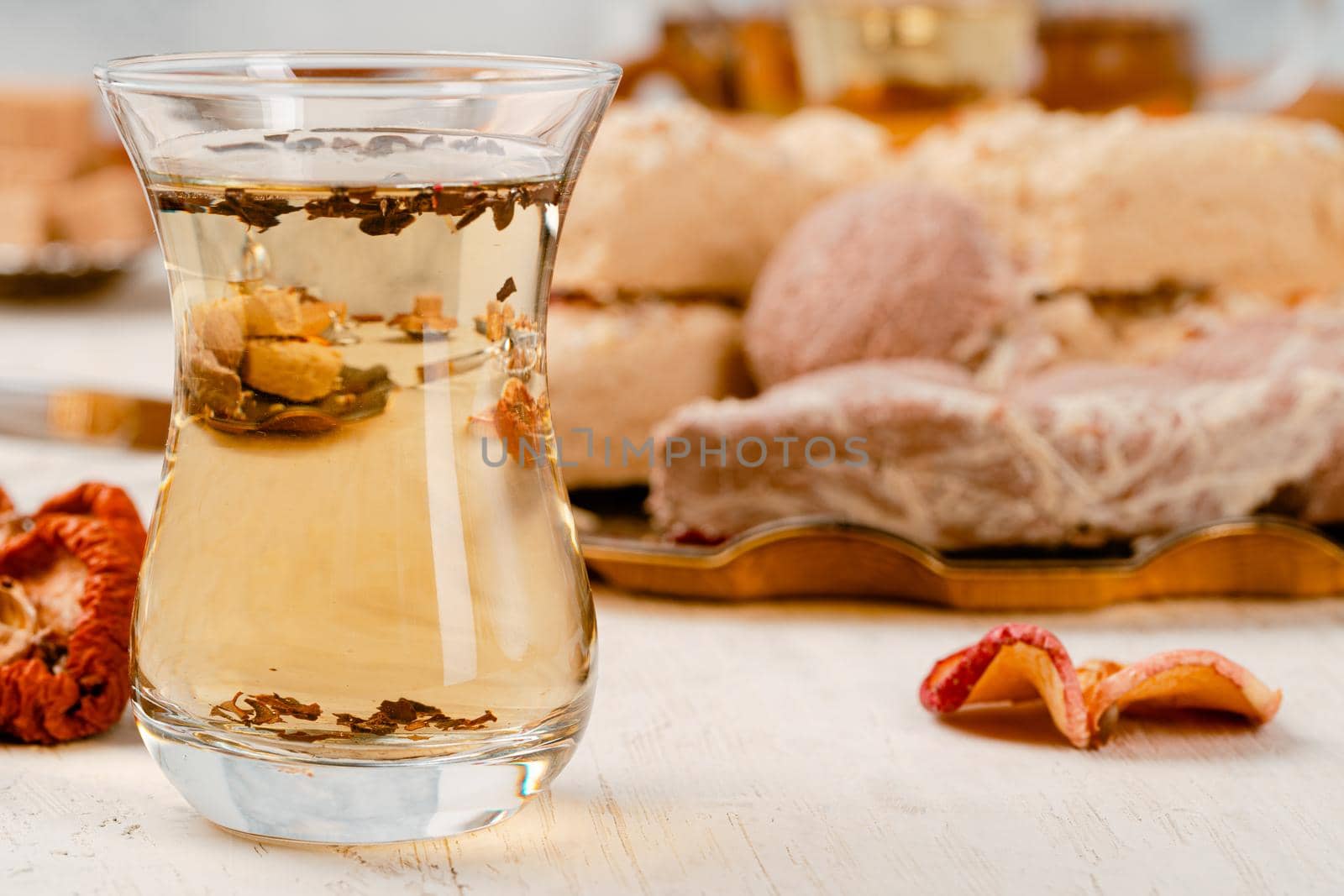 Turkish halva with tea in a glass cup close up on table