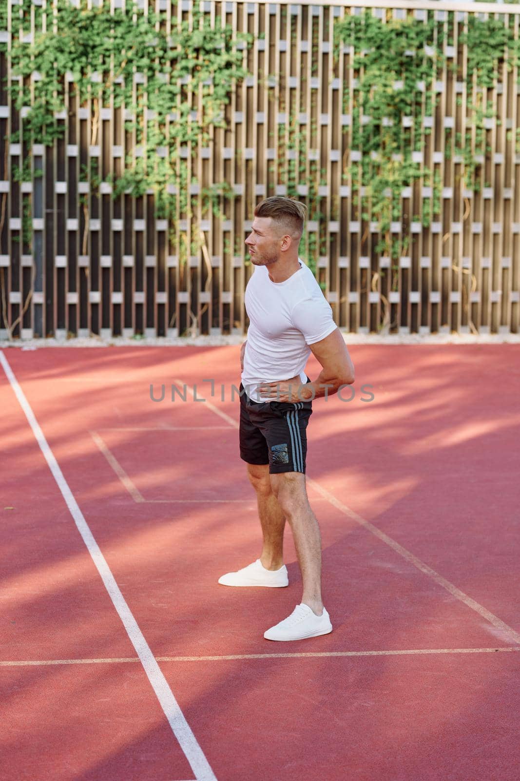 athletic men doing exercises on the sports ground in summer. High quality photo