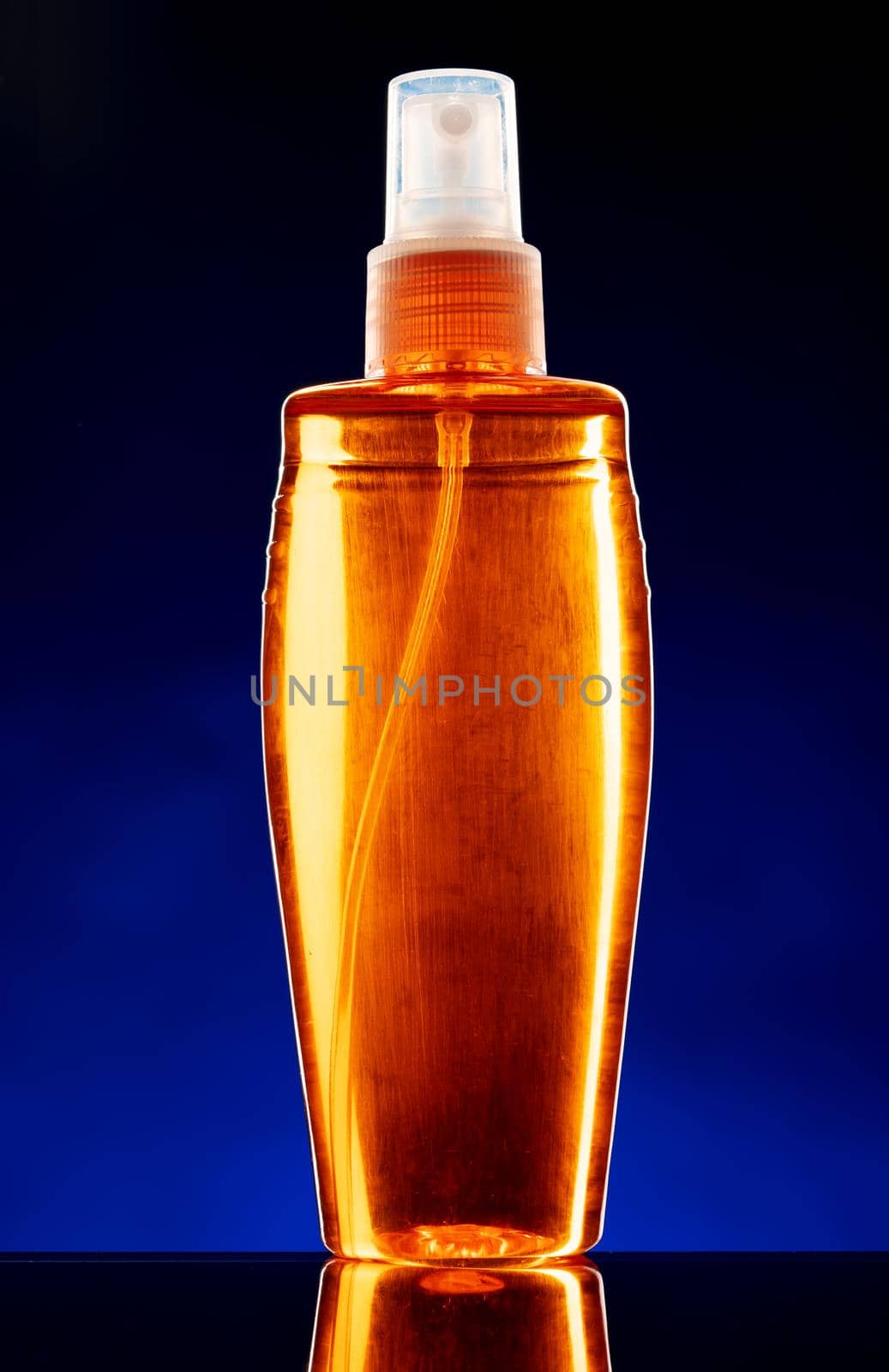 Glass bottle with cosmetic oil on dark background by Fabrikasimf