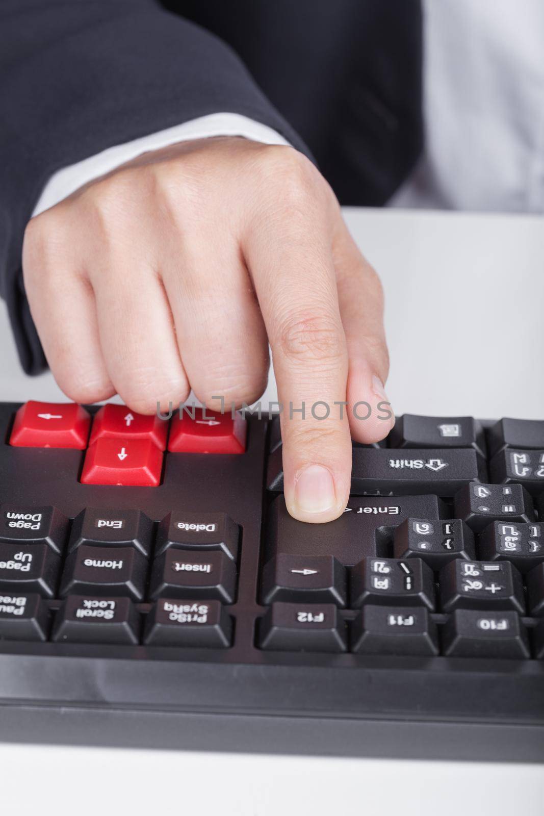 finger pushing enter button on keyboard of computer by geargodz