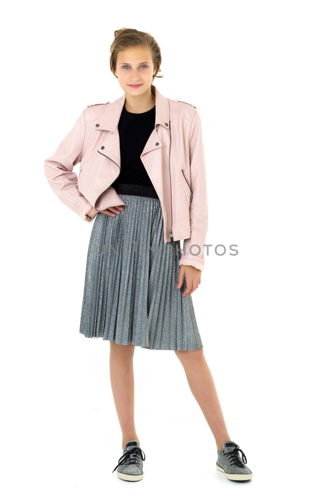 Pretty fashionable stylish teenage girl. Full length shot of beautiful teen girl wearing leather jacket, gray skirt and shoes standing on isolated white background