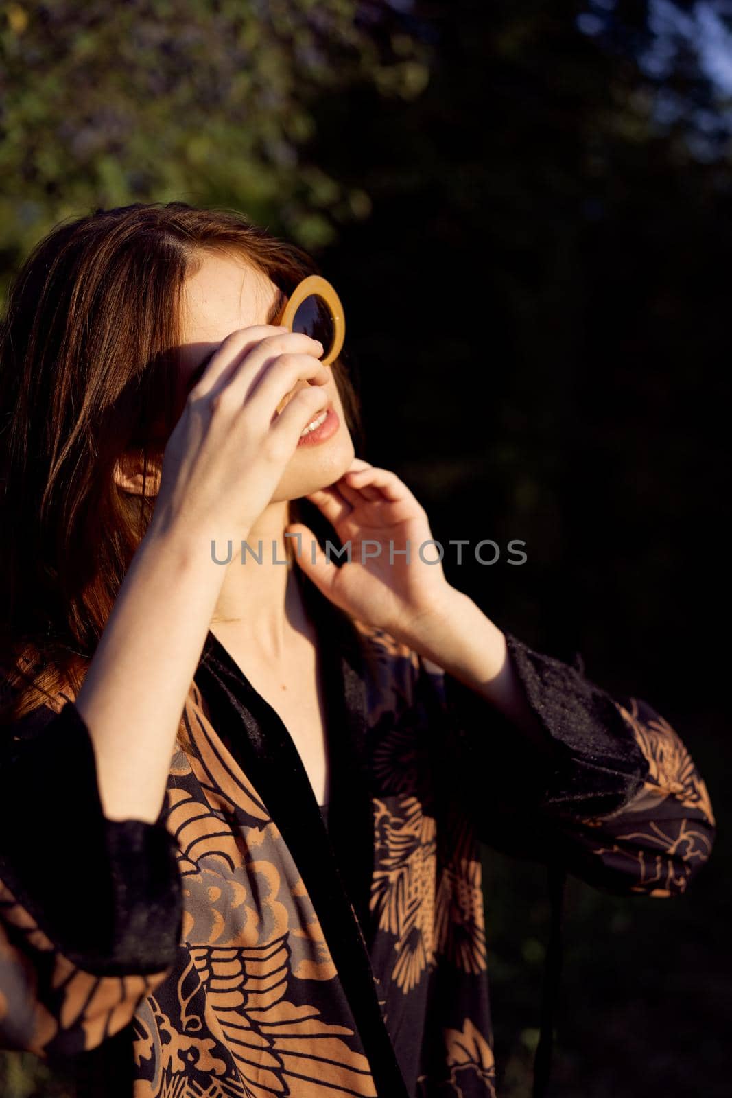 pretty woman wearing sunglasses outdoors fashion nature. High quality photo