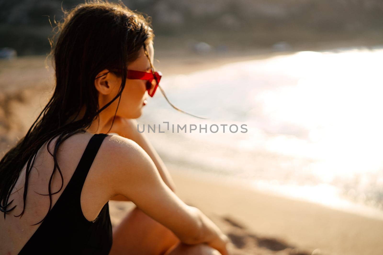 woman in a black swimsuit on the beach sea Summer vacation. High quality photo