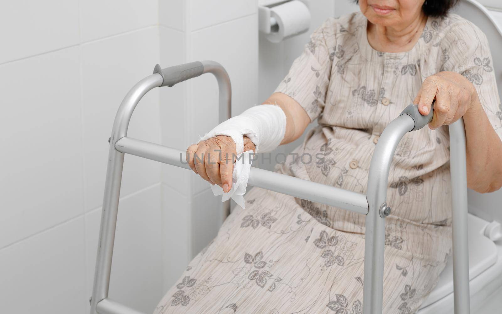 Senior women using the toilet with walker.