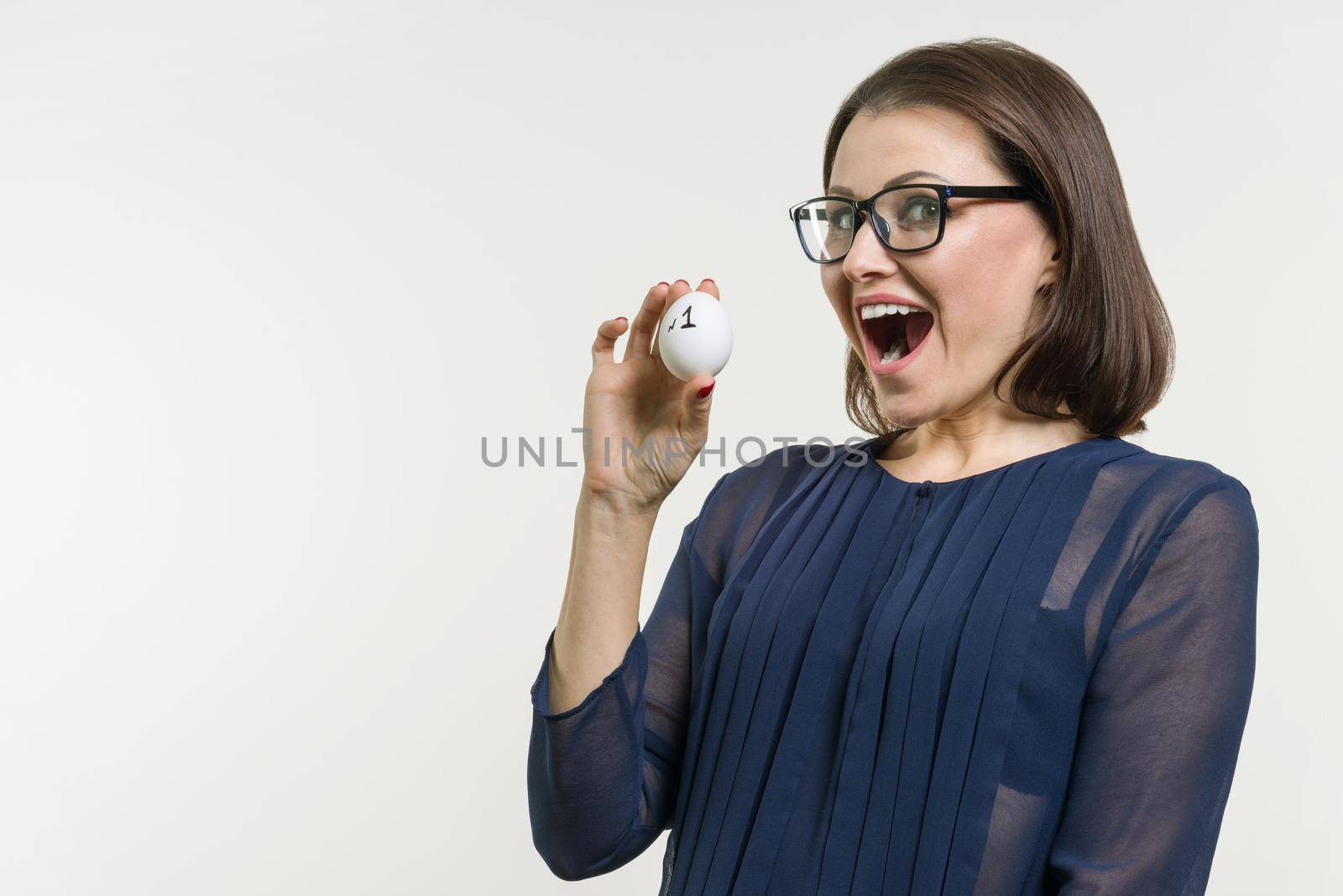 Businesswoman shows number 1. Abstract egg with text number one, white background.