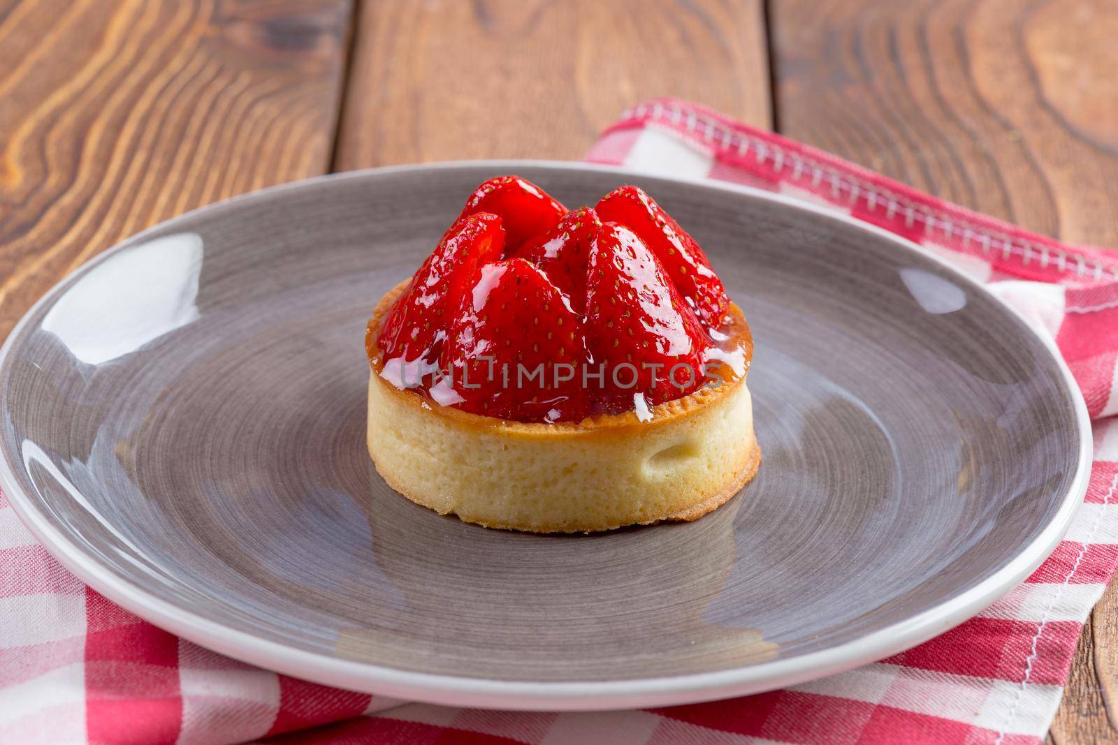 Mini tart with strawberries close up. Sweet berry dessert