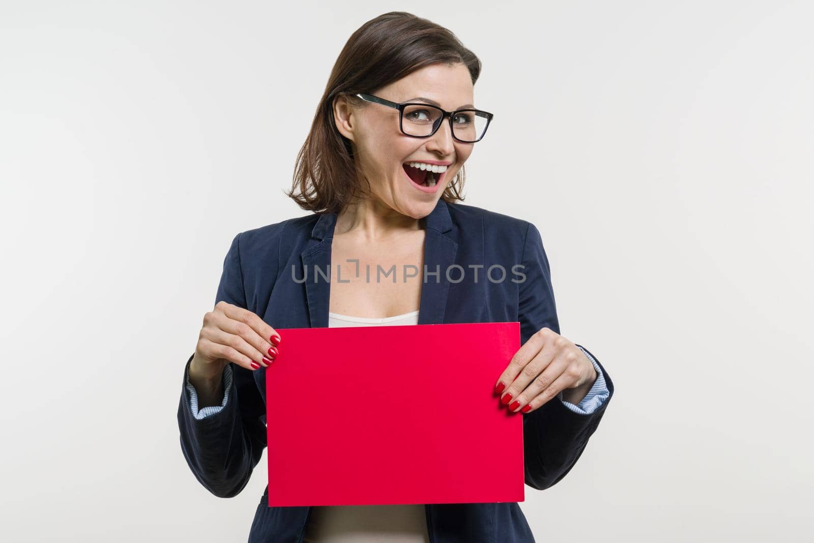 Smiling woman with red sheet of paper on white background by VH-studio
