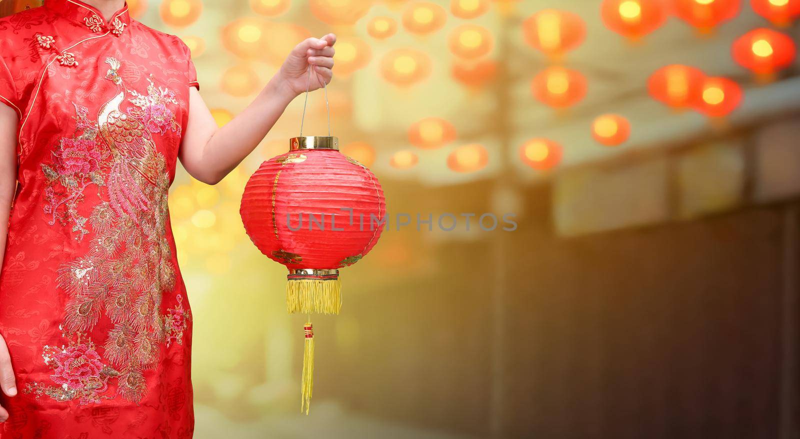 woman holding chinese new year lanterns in china town by toa55