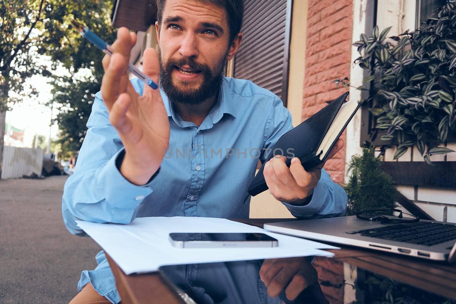 bearded man with laptop in cafe working. High quality photo