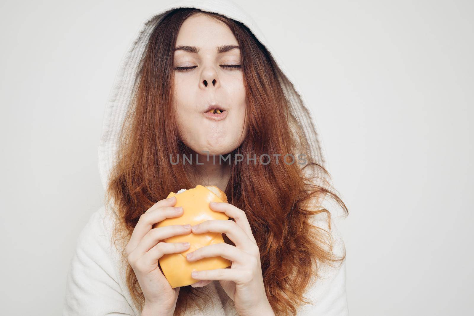 red-haired woman eating a sandwich snack lunch by Vichizh