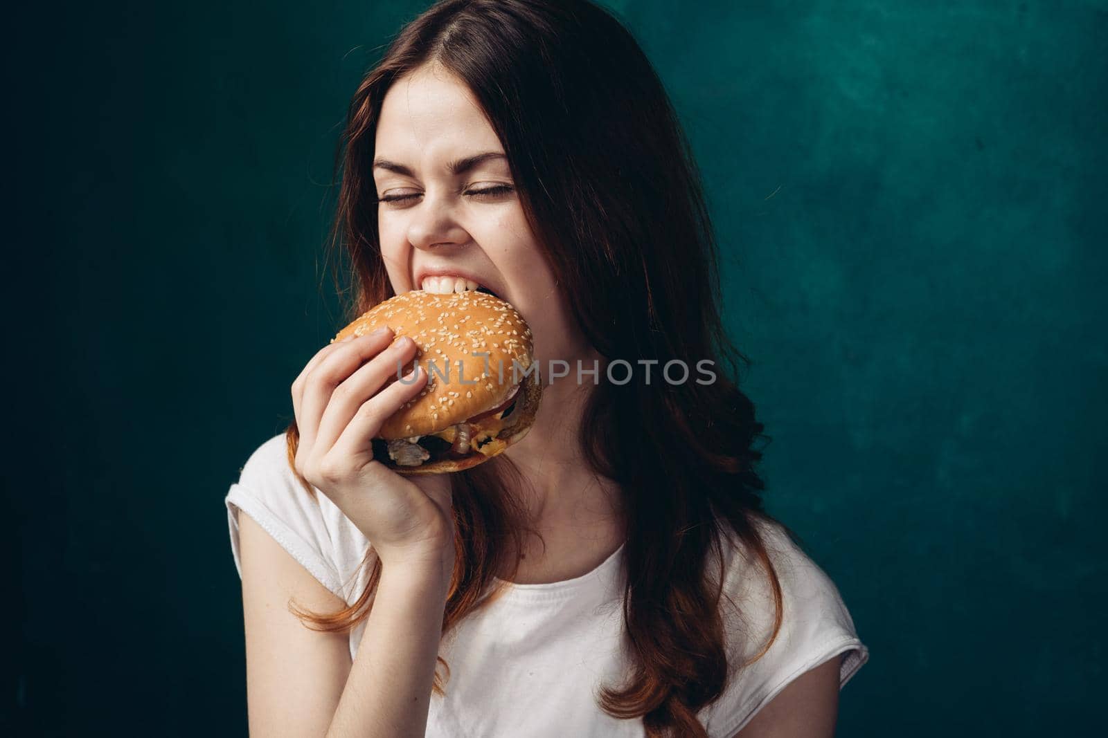 cheerful woman eating hamburger snack close-up lifestyle. High quality photo