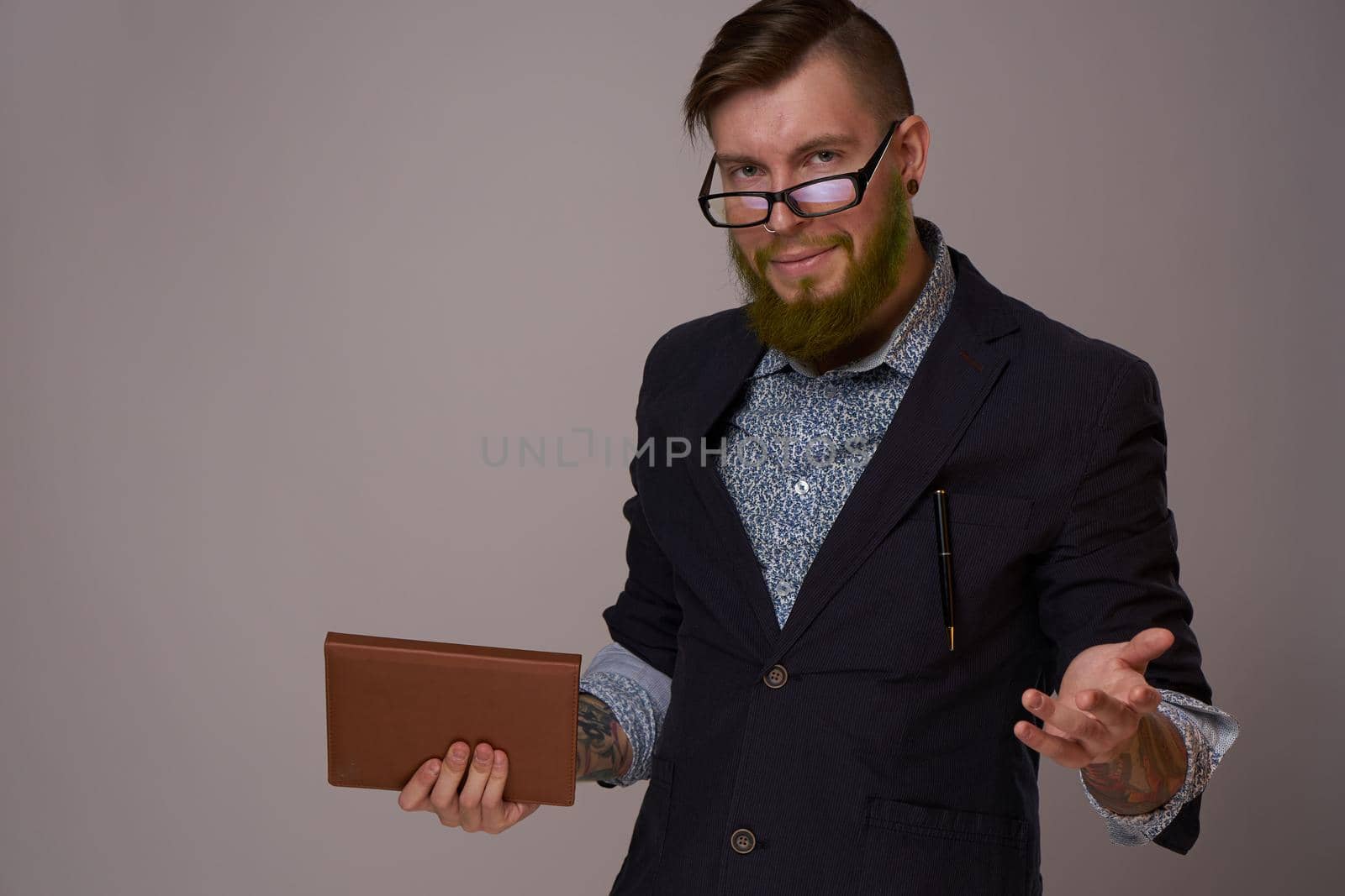 business man with glasses with tattoos on his arms office professionals. High quality photo