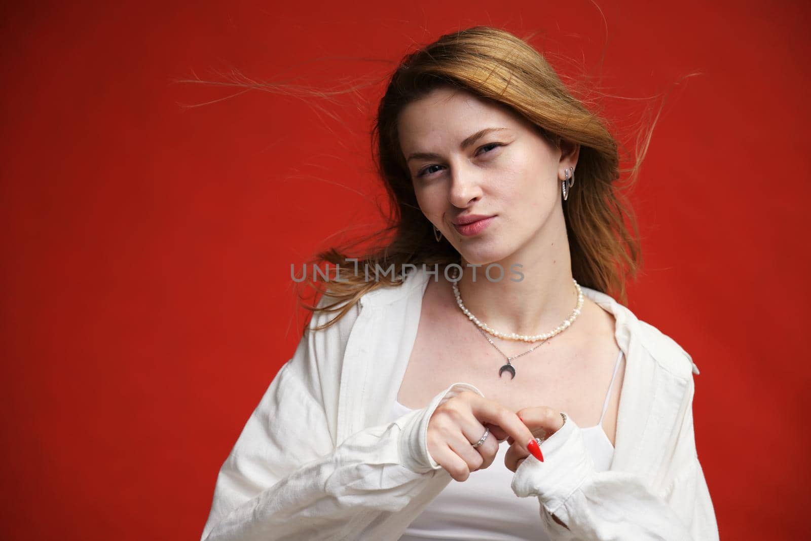 young european girl portrait on red background in studio