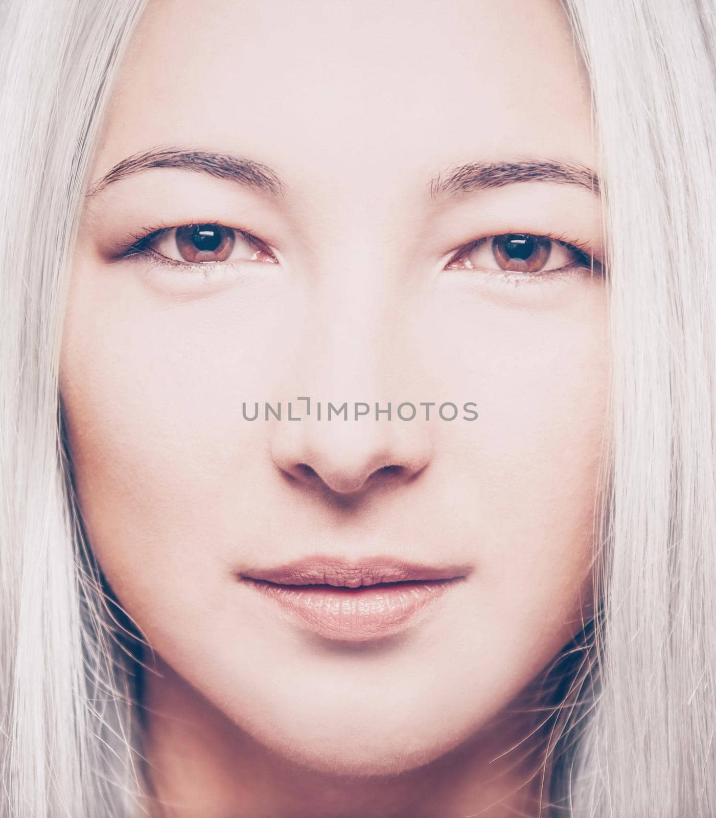 Close-up portrait of a blonde mixed race young woman, looking at camera. Beauty concept.