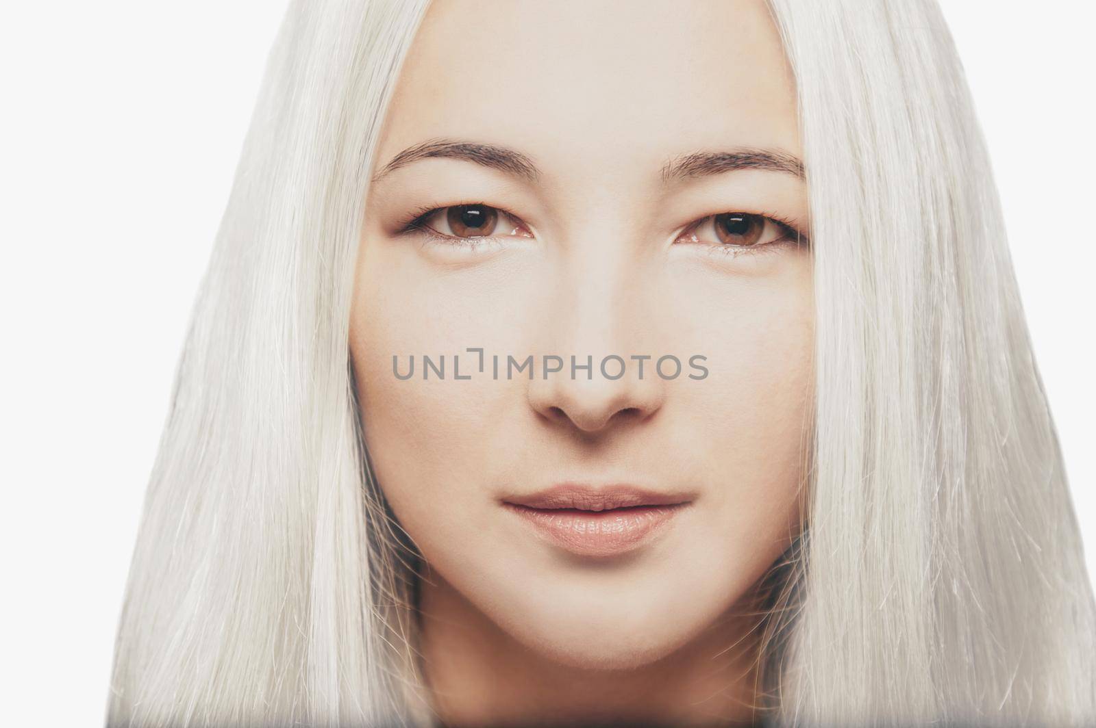 Portrait of a blonde mixed race young woman, looking at camera. Hairstyle.
